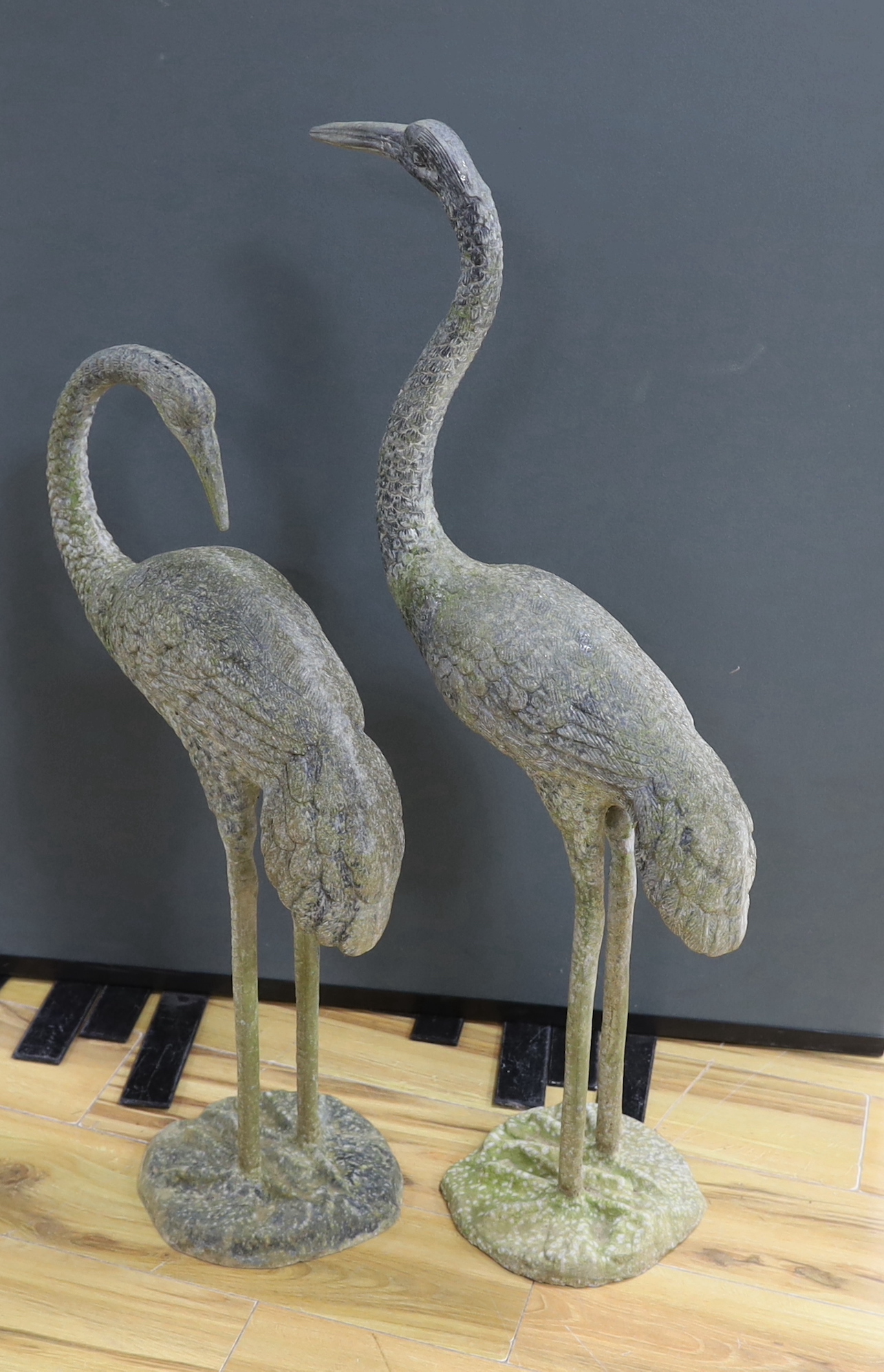 A large pair of weathered metal storks, 95cm